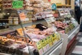 Chiller display of food on sale in delicatessen showing food and price signs