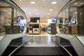 Escalator exit inside a modern department store exiting to technology electronics department Royalty Free Stock Photo