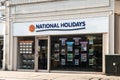 Exterior of National Holidays store travel agent for coach holidays showing company sign, signage, logo, branding, window display