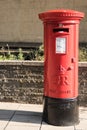 Exterior Red Royal Mail Pillar Post Box on street Royalty Free Stock Photo