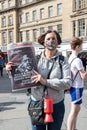 Fundraising protester wearing face mask holding a copy of the Socialist paper at Anti-racism and black lives matters protest rally