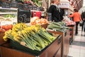 Indoor fruit and vegetable market stall showing daffodil flowers, fruit and veg Royalty Free Stock Photo