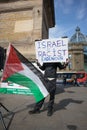 Man holding placard at the Free Palestine Rally