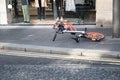 Mobike rental bicycle lying on it`s side on a pavement sidewalk