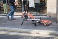 Mobike rental bicycle lying on it`s side on a pavement sidewalk