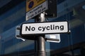 No cycling sign on metal pole. Isolated against building in the background