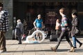 Street musician busker waits to perform on busy shopping street Royalty Free Stock Photo