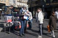 Young adult male holding copies of Socialist Worker