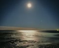 Star trails over pacific ocean bright moon shining on water landscape colour night Newcastle New South Wales Australia Royalty Free Stock Photo