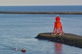 Newcastle, United Kingdom - October 5th, 2014 - Becalmed sailing dinghy in the mouth of the river Tyne is being towed ashore by a Royalty Free Stock Photo