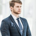 Newcomer businessman in a business suit stands near the window Royalty Free Stock Photo