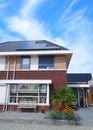 Newly build house in the Netherlands with solar panels attached on the roof against a sunny sky Close up of new building Royalty Free Stock Photo