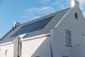 Newly build house in the Netherlands with solar panels attached on the roof against a sunny sky Close up of new building Royalty Free Stock Photo