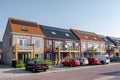 Newly build houses with solar panels attached on the roof against a sunny sky Close up of new building with black solar Royalty Free Stock Photo