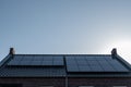 Newly build houses with solar panels attached on the roof against a sunny sky Close up of new building with black solar Royalty Free Stock Photo