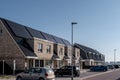 Newly build houses with solar panels attached on the roof against a sunny sky Close up of new building with black solar Royalty Free Stock Photo