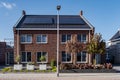 Newly build houses with solar panels attached on the roof against a sunny sky Close up of new building with black solar Royalty Free Stock Photo