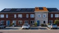 Newly build houses with solar panels attached on the roof against a sunny sky, housing market