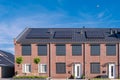 Newly build houses with solar panels attached on the roof against a sunny sky Royalty Free Stock Photo