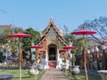 Red parasols line the way to a temple in northern Thailand