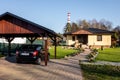 A newly built family house with a wooden garage and a black car