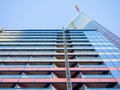 A newly built house. Glazed skyscraper. Reflection of the sky in the windows. Multi-apartment modern housing