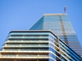 A newly built house. Glazed skyscraper. Reflection of the sky in the windows. Multi-apartment modern housing