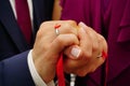 Newly engaged couple hands with ribbon close up view