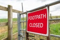Newly erected Footpath Closed sign seen attached to a fence at a public footpath area.