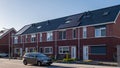 Newly houses with solar panels attached on the roof against a sunny sky, housing market Netherlands