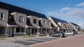 Newly houses with solar panels attached on the roof against a sunny sky, housing market Netherlands