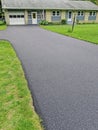 Newly installed asphalt driveway and home in Summer