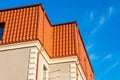 Newly installed construction frame house rain gutter system on the red metal roof top. Royalty Free Stock Photo