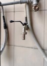 Newly installed metal outside water tap spigot stainless steel faucet for gardens connected to old pipes. Royalty Free Stock Photo