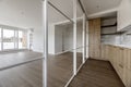 Newly installed modern kitchen with a quartz-like stone countertop and light wood cabinets in an empty apartment with access to Royalty Free Stock Photo