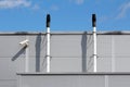 Newly Installed Narrow Metal Pipes Used For Ventilation With Protective Cap On Top Next To Closed Circuit TV CCTV Security Camera