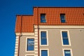 Newly installed red metal roof top and building construction frame rain gutter system. Royalty Free Stock Photo