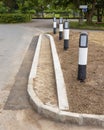 Newly laid roadside kerb on a grass verge with newly seeded grass guard blocks