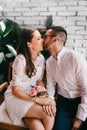 Newlywed couple caressing and kissing on their wedding day. Love concept