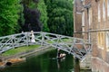 A newly married couple celebrate on the Mathematical Bridge across the river Cam