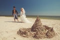 Newly-married couple enjoying on the beach