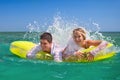 Newly-married couple enjoying on an inflatable mattress