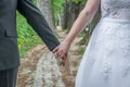 A newly married couple in front of the symbolic path of life in a fairytale forest, Germany