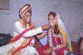 A newly married couple of Hindus sweeten each other.