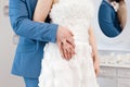 Newly married couple holding hands with woman`s hand on top of man`s hand