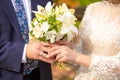 Newly married couple holding wedding bouquet of lilies Royalty Free Stock Photo