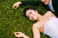 Newly-married couple Lie on green grass