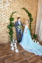 Newly married couple, loving couple before the wedding. Man and woman loving each other. Bride in the turquoise dress and groom Royalty Free Stock Photo