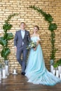 Newly married couple, loving couple before the wedding. Man and woman loving each other. Bride in the turquoise dress and groom Royalty Free Stock Photo