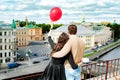 The newly married couple on the roof of house in red sunset with bubbles Royalty Free Stock Photo